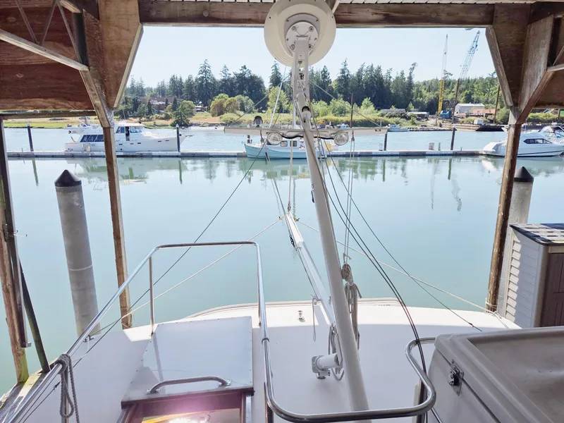 Slide: The Image of 1990 Grand Banks 36 Europa docked in a serene marina setting. - 37