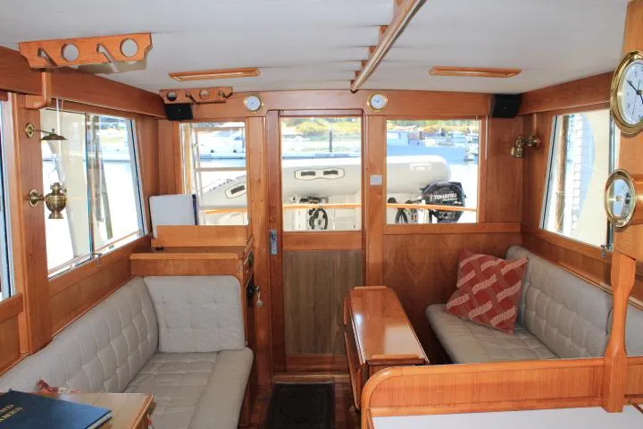 Slide: The Image of Interior of 1990 Grand Banks 36 Europa yacht with wooden finish and comfortable seating. - 38