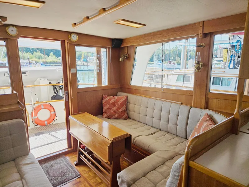 Slide: The Image of Interior of 1990 Grand Banks 36 Europa yacht with cozy seating and wooden accents. - 40