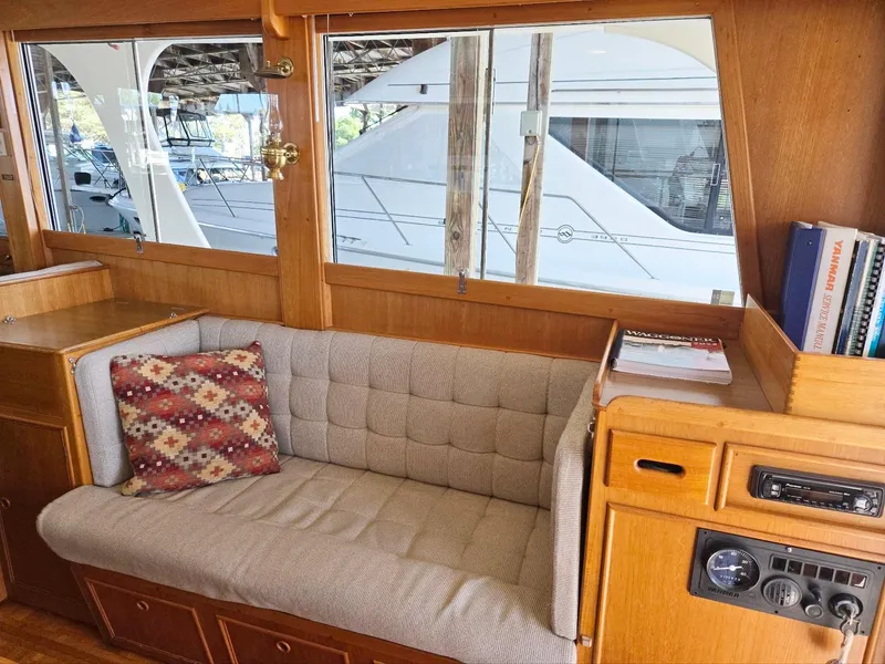 Slide: The Image of Interior of 1990 Grand Banks 36 Europa yacht with cozy seating and nautical decor. - 42