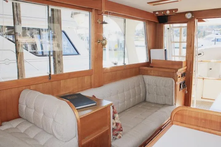 Slide: The Image of Interior of 1990 Grand Banks 36 Europa yacht with wood paneling and cushioned seating. - 43