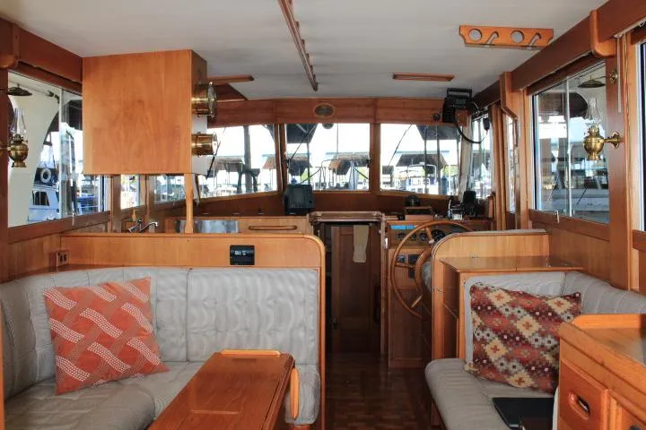 Slide: The Image of Interior of a 1990 Grand Banks 36 Europa yacht with wooden furnishings and cozy seating. - 44