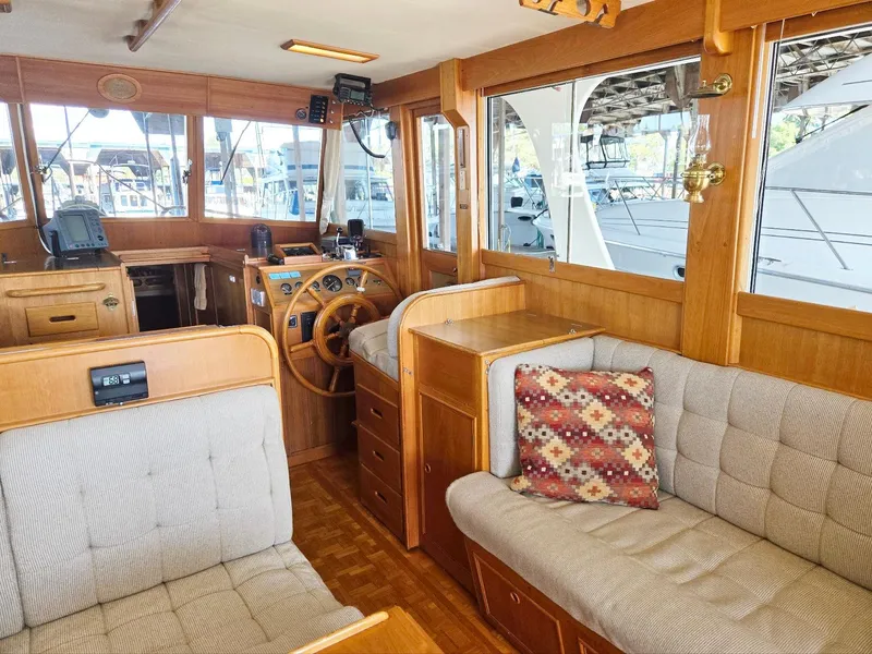 Slide: The Image of Interior of 1990 Grand Banks 36 Europa yacht with wooden helm and cozy seating. - 45