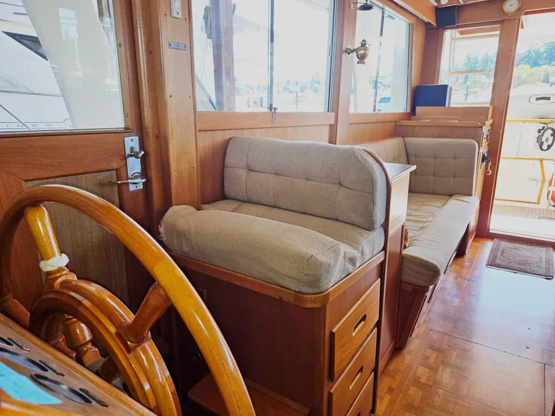 Slide: The Image of Interior of 1990 Grand Banks 36 Europa yacht with wooden helm and cushioned seating. - 47