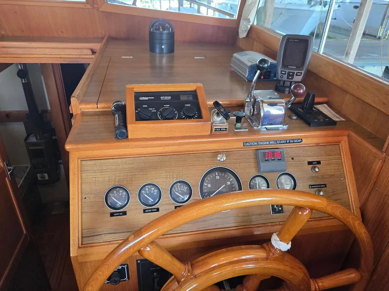 Slide: The Image of Helm of 1990 Grand Banks 36 Europa with wooden wheel and navigation instruments. - 48