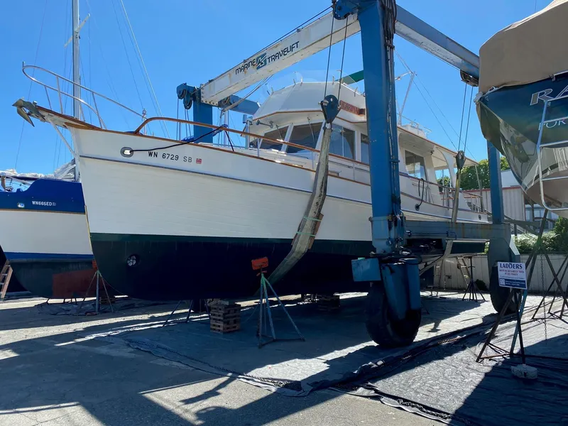 Slide: The Image of 1990 Grand Banks 36 Europa yacht in dry dock, supported by a marine travel lift. - 6