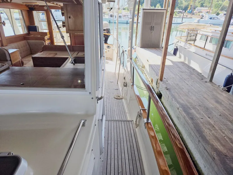 Slide: The Image of 1990 Grand Banks 36 Europa yacht interior and deck, docked at marina. - 9