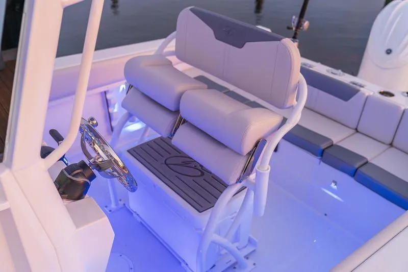 Slide: The Image of Interior of 2026 Sailfish 232 CC boat with illuminated seating and steering wheel. - 12