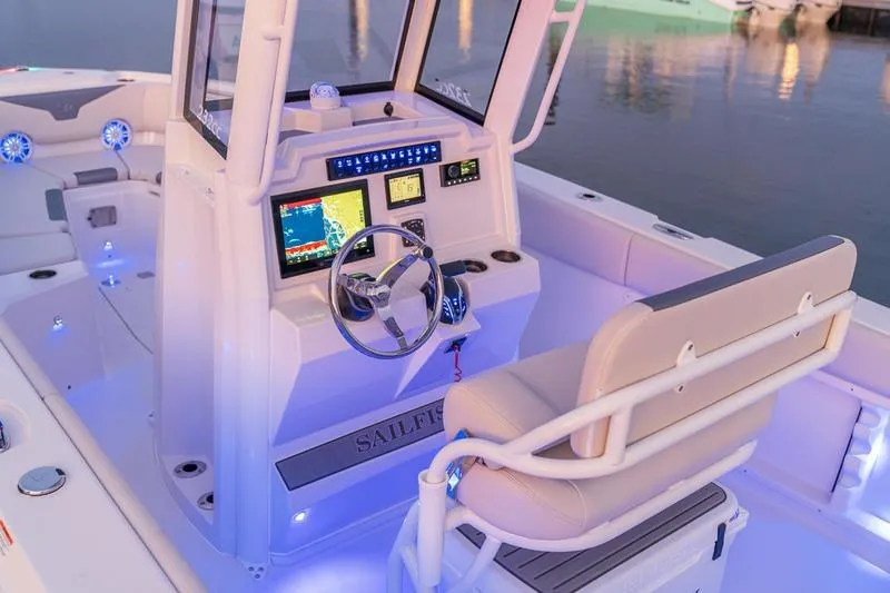 Slide: The Image of 2026 Sailfish 232 CC boat interior with illuminated dashboard and seating. - 15