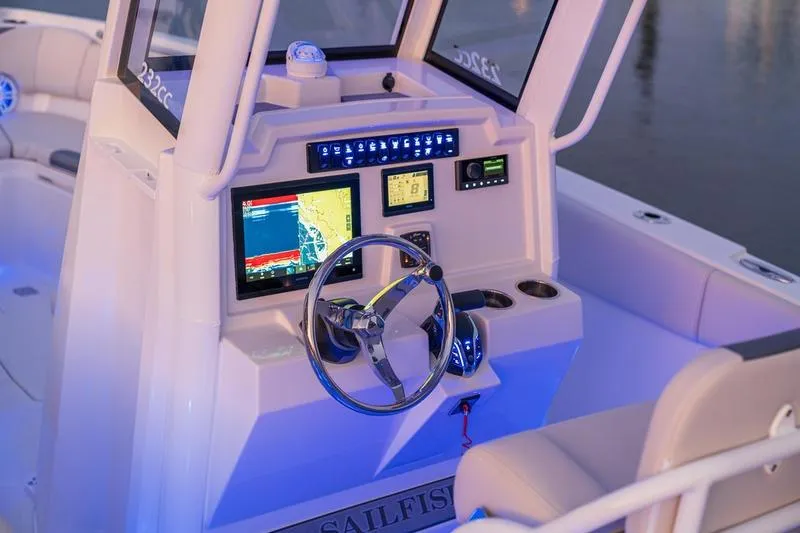 Slide: The Image of 2026 Sailfish 232 CC boat dashboard with illuminated controls and navigation screens. - 16