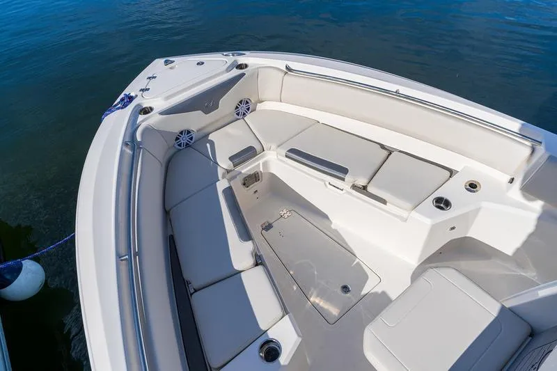 Slide: The Image of 2026 Sailfish 232 CC boat interior with cushioned seating and cup holders. - 17