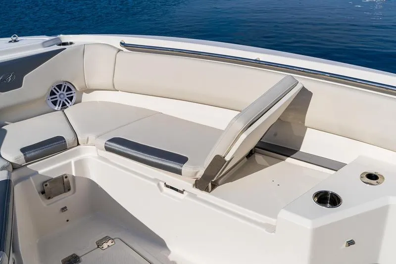 Slide: The Image of 2026 Sailfish 232 CC boat interior with cushioned seating and cup holder. - 18