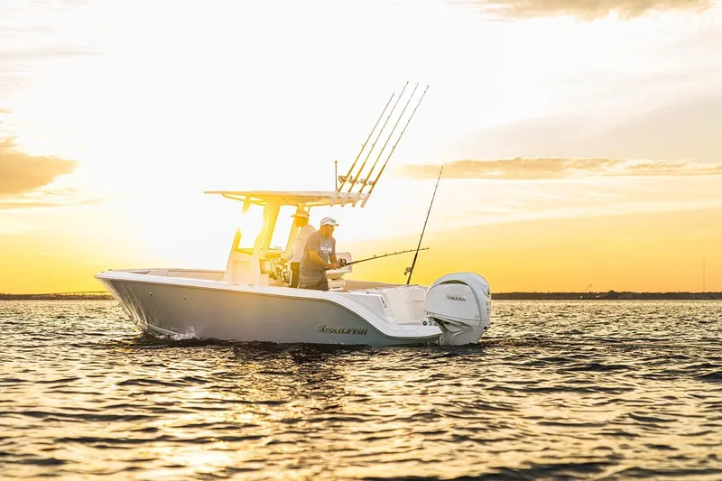 Slide: The Image of 2026 Sailfish 232 CC boat cruising on open water, equipped for fishing. - 2