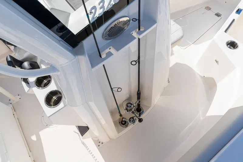 Slide: The Image of 2026 Sailfish 232 CC boat interior with fishing rods and cup holders. - 21