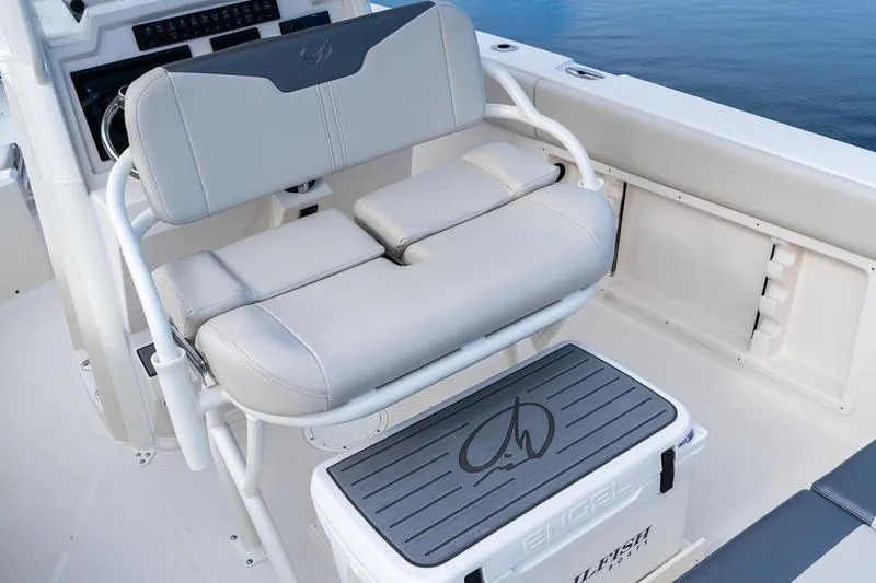 Slide: The Image of 2026 Sailfish 232 CC boat interior with cushioned seating and storage compartment. - 26