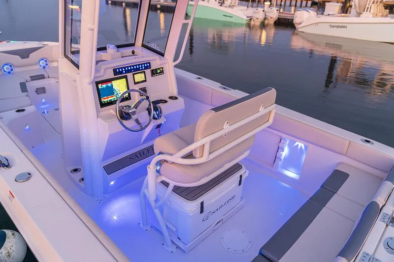Slide: The Image of 2026 Sailfish 232 CC boat with open storage compartment and portable toilet. - 7