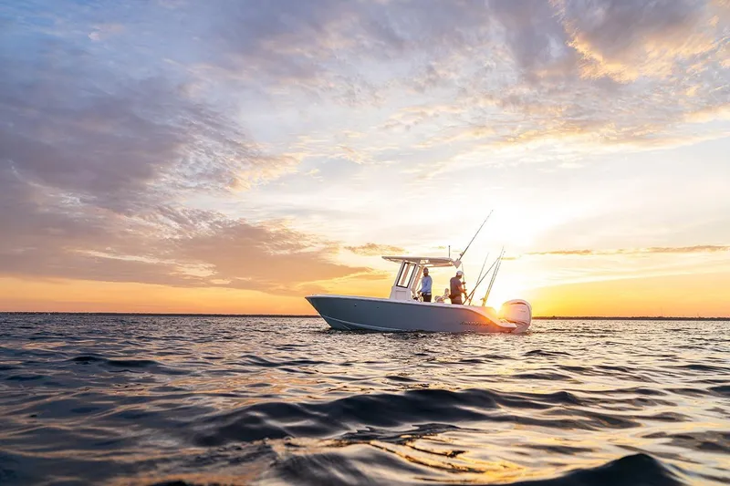 Slide: The Image of 2026 Sailfish 232 CC boat cruising on open water with fishing rods. - 8