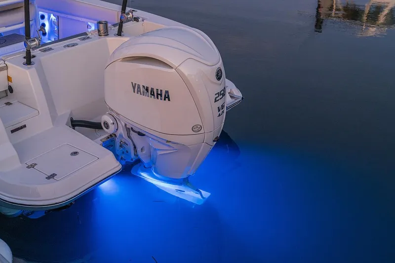 Slide: The Image of Sailfish 232 CC 2026 boat with Yamaha engine, illuminated by blue underwater lights. - 9