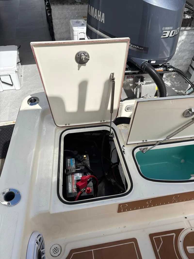 Slide: The Image of Open hatch on 2019 BlackJack 224 boat showing battery compartment and Yamaha engine. - 13