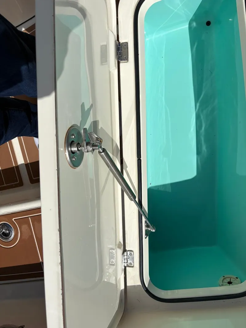 Slide: The Image of Open storage compartment on a 2019 BlackJack 224 boat, showing interior details. - 25