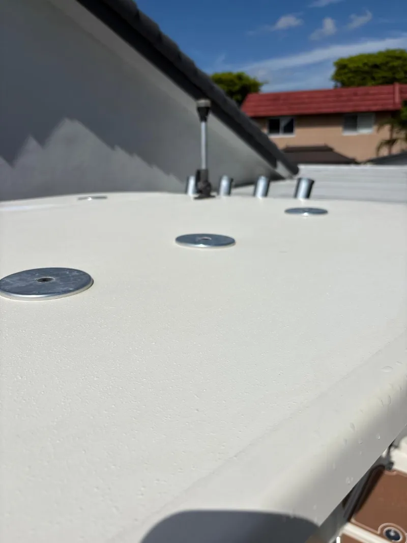 Slide: The Image of 2019 BlackJack 224 boat deck with metal fixtures under a clear blue sky. - 29