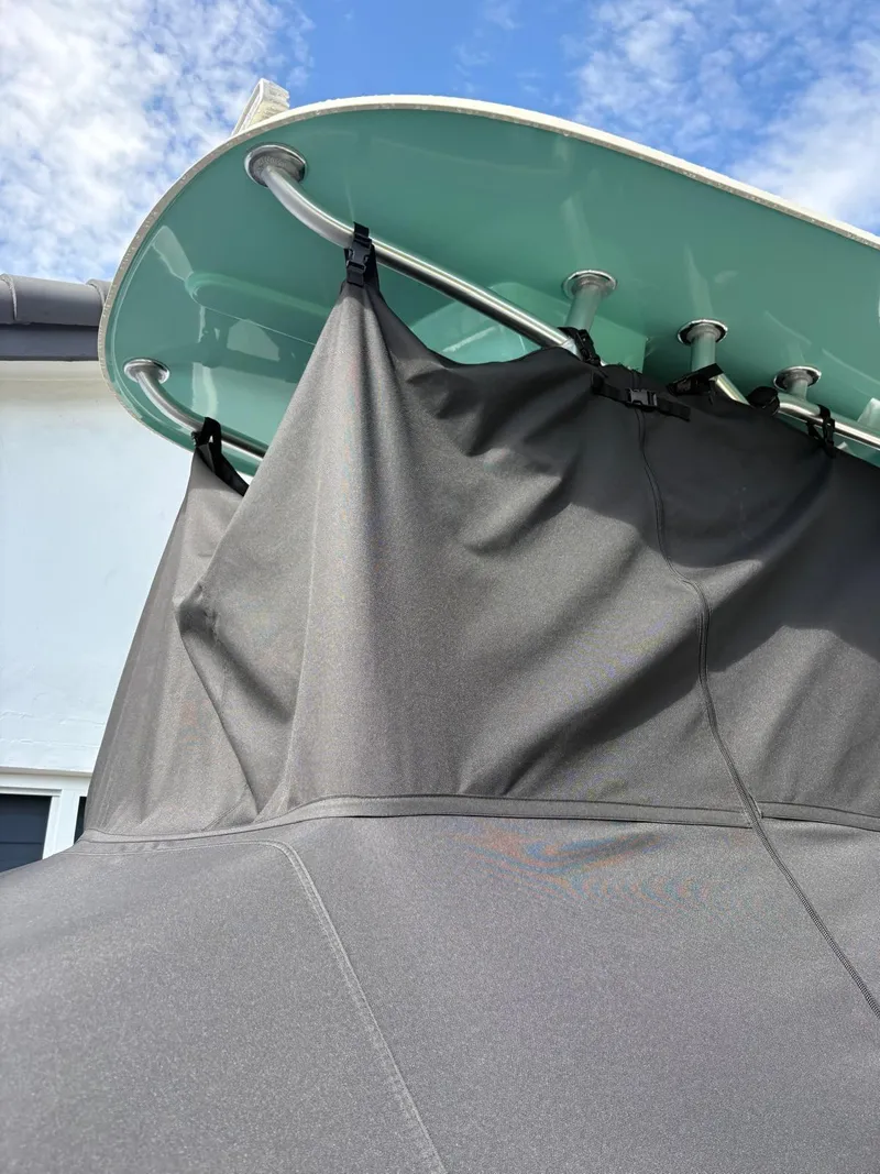 Slide: The Image of BlackJack 224 boat with protective cover, 2019 model, under a clear blue sky. - 40