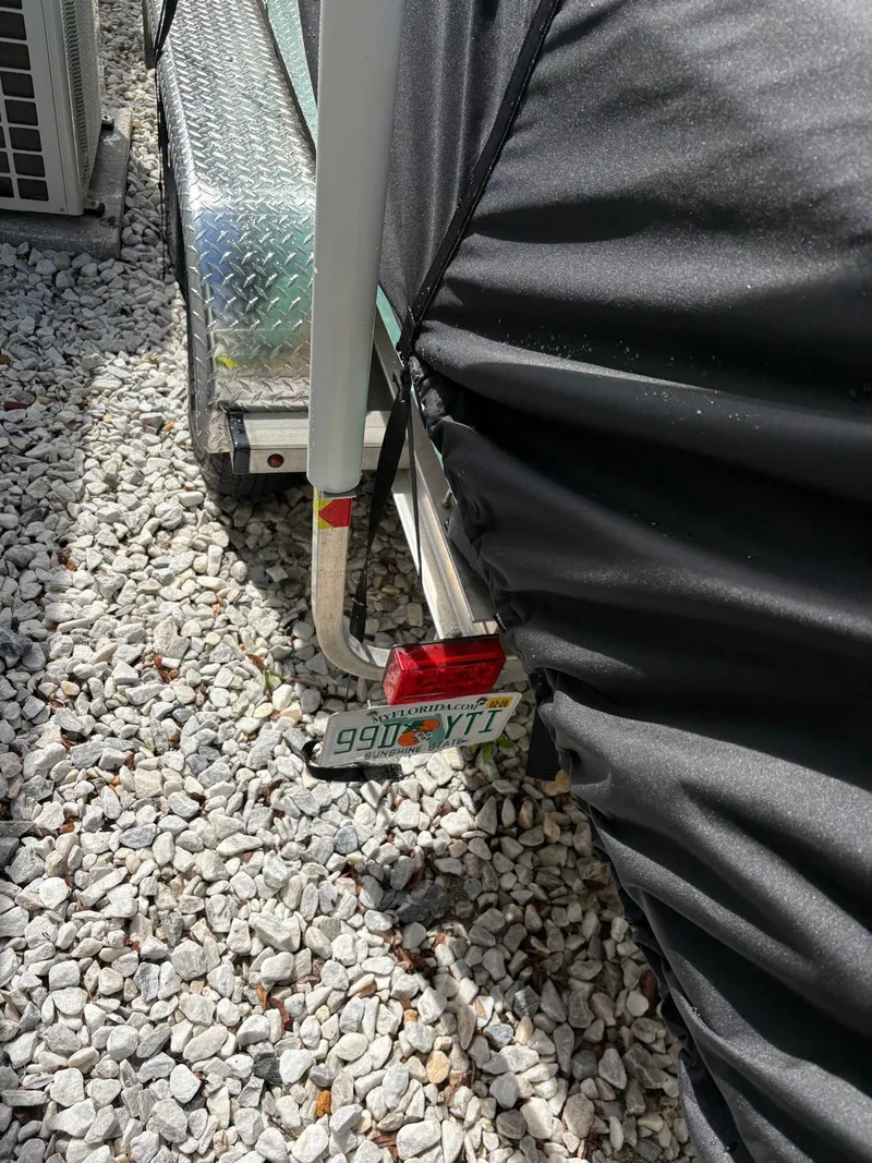 Slide: The Image of Trailer with Florida license plate on gravel, BlackJack 224 model, 2019. - 44