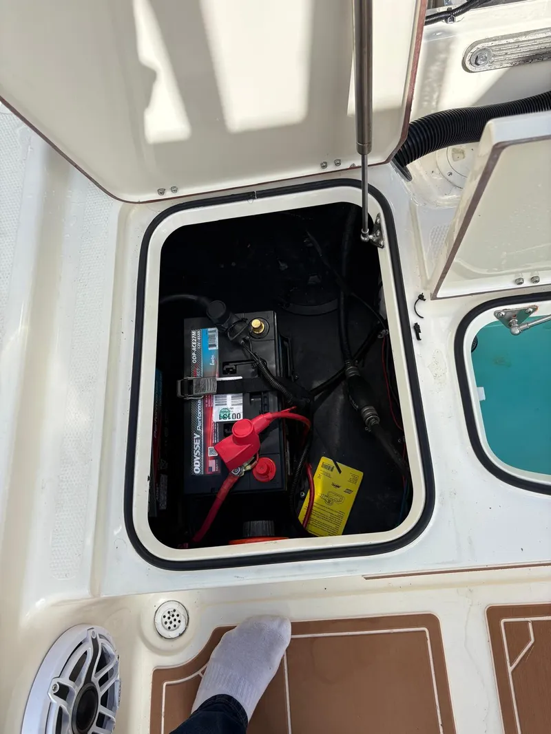 Slide: The Image of Open hatch of a 2019 BlackJack 224 boat showing battery compartment. - 7