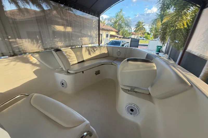 Slide: The Image of 2017 Century 2600 Center Console boat interior under canopy, parked near palm trees. - 21