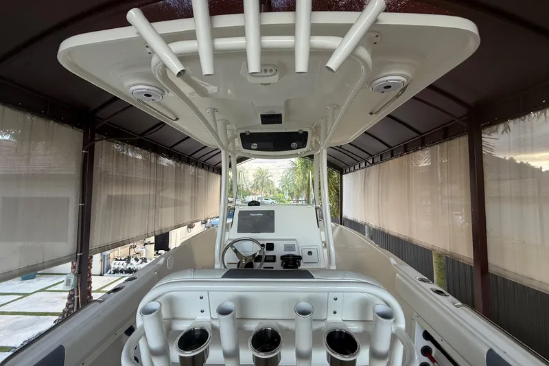 Slide: The Image of 2017 Century 2600 Center Console boat interior with cushioned seating and dual engines. - 6