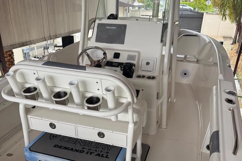 Slide: The Image of 2017 Century 2600 Center Console boat interior with rod holders and steering console. - 7