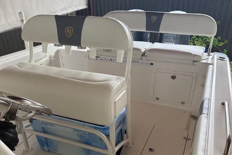 Slide: The Image of 2017 Century 2600 Center Console boat interior with steering wheel and rod holders. - 8