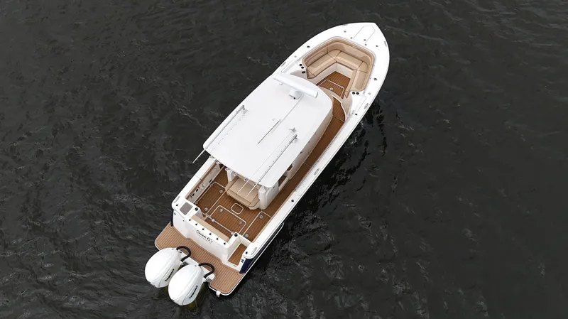 Slide: The Image of Aerial view of 2022 Scout 330 LXF boat on water, featuring dual engines. - 10