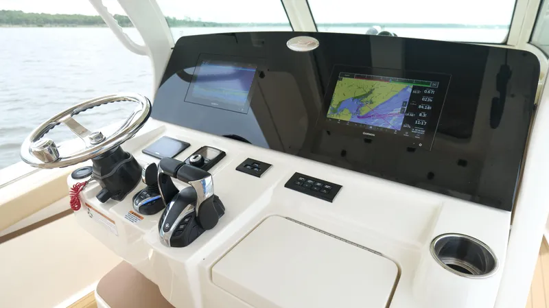Slide: The Image of 2022 Scout 330 LXF helm with steering wheel, navigation screens, and controls. - 14