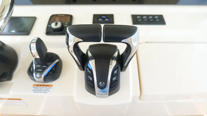 Slide: The Image of Control panel of 2022 Scout 330 LXF boat with throttle and joystick. - 16