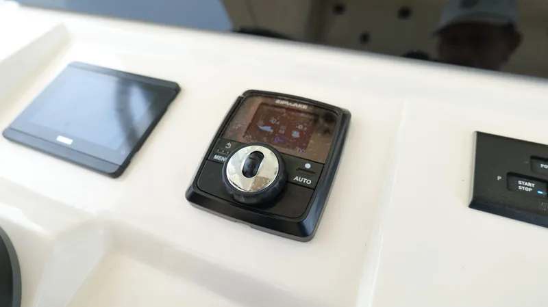 Slide: The Image of Control panel of 2022 Scout 330 LXF boat with navigation and start-stop features. - 18