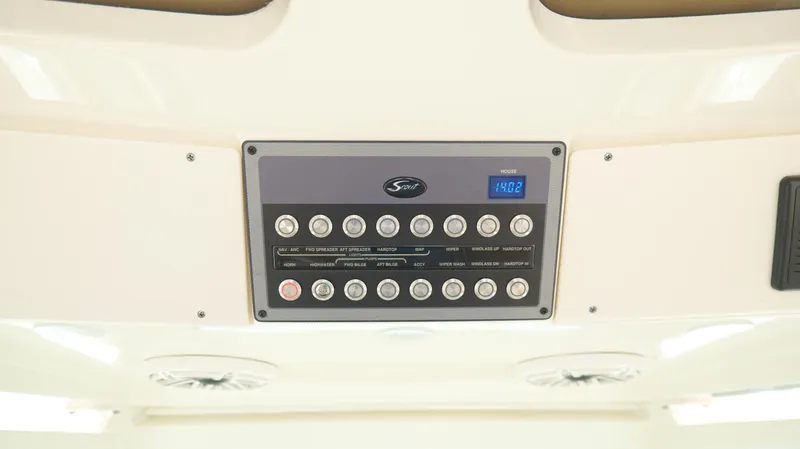 Slide: The Image of Control panel of 2022 Scout 330 LXF boat with various switches and digital display. - 19
