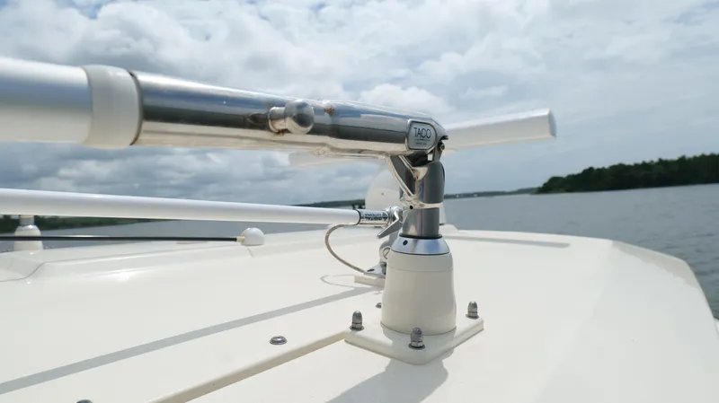 Slide: The Image of Close-up of 2022 Scout 330 LXF boat's metal fixture on deck, with water and sky background. - 24
