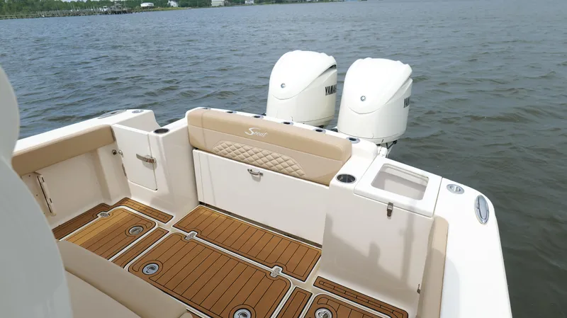 Slide: The Image of 2022 Scout 330 LXF boat with Yamaha engines on a calm lake. - 26