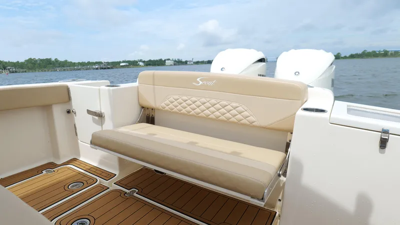 Slide: The Image of 2022 Scout 330 LXF boat interior with beige seating and teak flooring. - 28