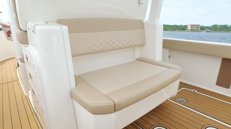 Slide: The Image of 2022 Scout 330 LXF boat interior with beige seating and teak flooring. - 29