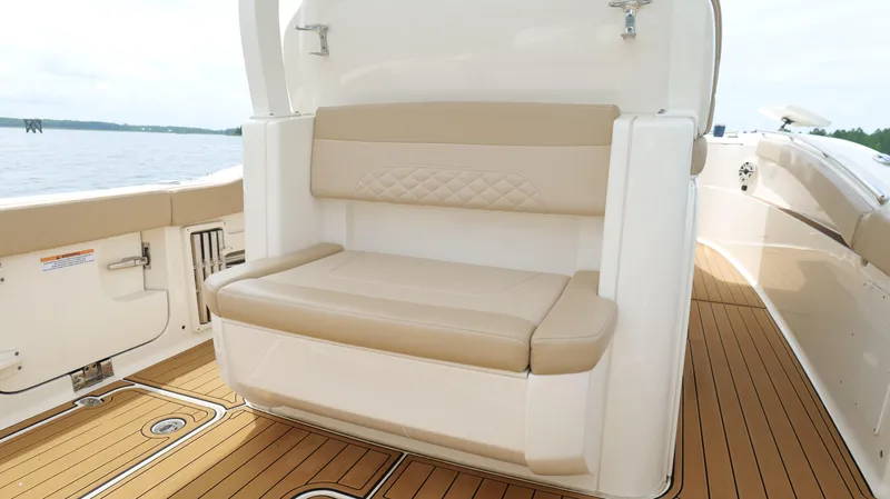 Slide: The Image of 2022 Scout 330 LXF boat interior with tan seating and teak flooring. - 30