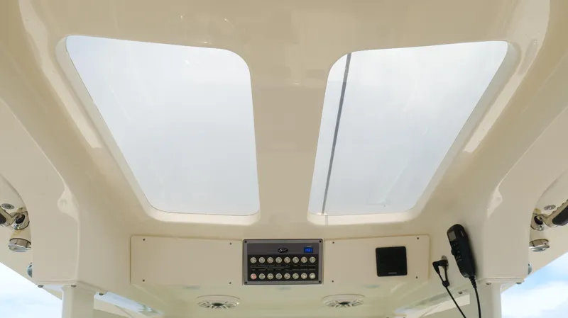 Slide: The Image of 2022 Scout 330 LXF boat interior with skylights and control panel. - 37
