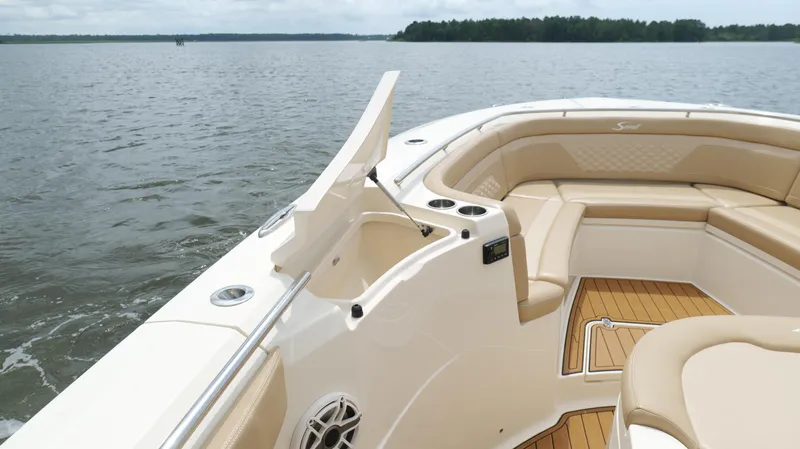Slide: The Image of 2022 Scout 330 LXF boat interior with tan seating and open water view. - 38