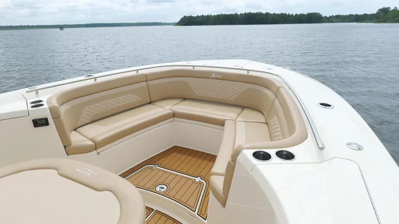 Slide: The Image of 2022 Scout 330 LXF boat with luxurious seating and scenic water view. - 42