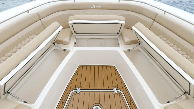 Slide: The Image of 2022 Scout 330 LXF boat interior with tan seating and wood flooring. - 44