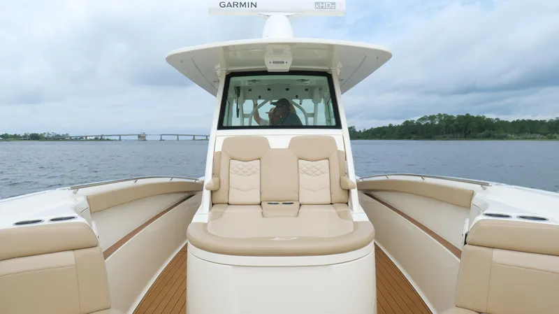 Slide: The Image of 2022 Scout 330 LXF boat on water, featuring luxurious seating and modern design. - 46