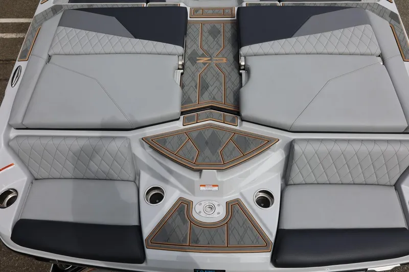 Slide: The Image of 2025 Tigé Z3 boat interior with sleek, quilted gray seating and stylish design accents. - 10
