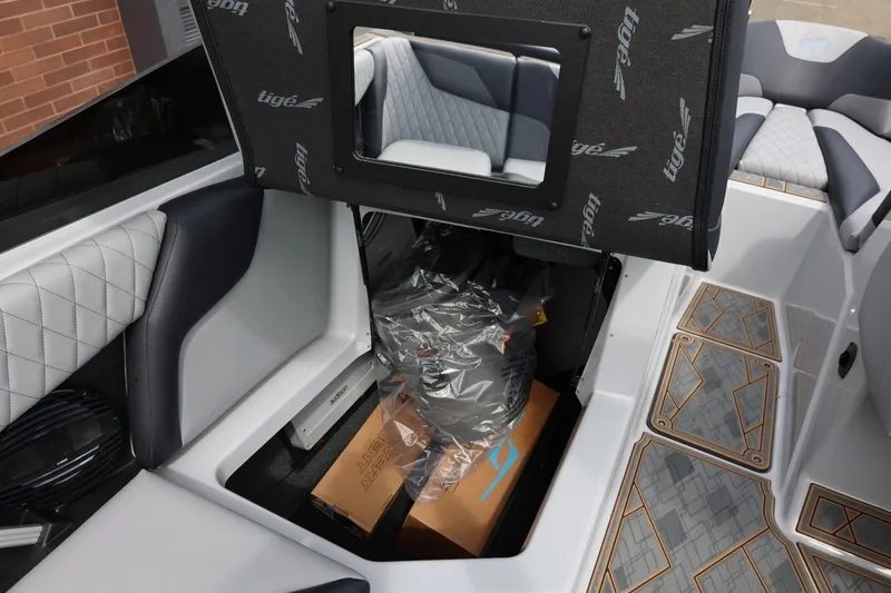 Slide: The Image of 2025 Tigé Z3 boat interior storage compartment with luxury seating and detailed flooring. - 26
