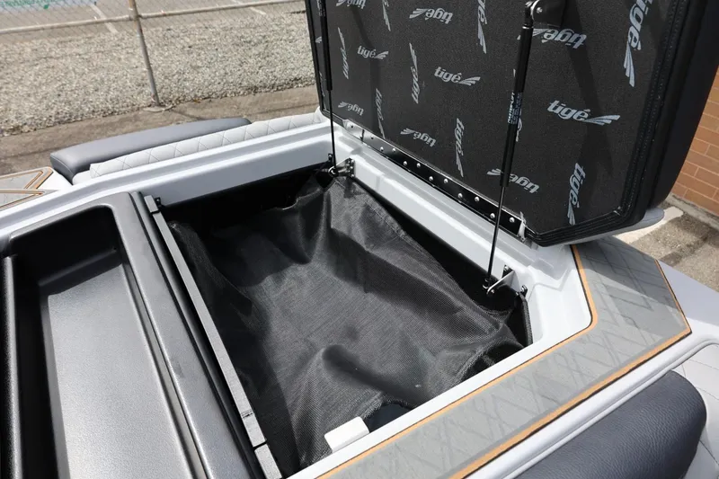 Slide: The Image of Open storage compartment of 2025 Tigé Z3 boat, showcasing interior design and materials. - 33